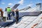 Workers building solar panel system on roof of house. Installers carrying photovoltaic solar module