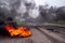 Workers burn tires in front of a factory during a protest in Firmat