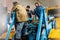 Workers-car mechanics at the service station of heavy road equipment