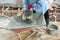 Workers carry mixed cement in dirty trolley at the construction site