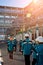 Workers of chemical factory in working clothes walks near large pipeline construction to their workplaces