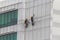 Workers cleaning or painting a multistory building