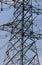 Workers climb as work on high voltage electric post.