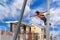 Workers climb the electric pole to install new equipment.