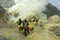 Workers collecting sulfur from volcano Ijen