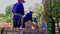 Workers Construct High Tower Flowerbed with Flowerpots