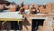 Workers on the construction of a house laying red bricks. Builders are building a brick wall of a high-rise building.