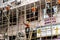 Workers on construction site building bamboo scaffolding on house facade in Hong Kong