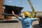 Workers in a construction site for the construction of large metal pipes