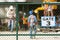 Workers in construction site, focus on chain link fence.