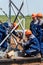 Workers at the construction site tighten the bolted joints of the base of the wind turbine truss tower