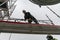 Workers dismantling temporary scaffolding wintertime