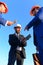 Workers and engineers hold meeting on blue sky background