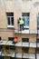 Workers erect scaffolding to repair the facade of a building