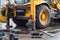 Workers excavate the pit with an excavator. Road repair.