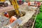 Workers and excavator is digging on building site