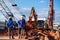 Workers with excavator drilling truck in construction site