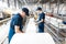 Workers in a factory carry out technological processes on a conveyor line in protective overalls