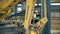 Workers, factory colleagues stand in a facility while a machine works with bricks.