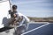 Workers Fixing Solar Panel On Roof Top