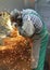 Workers in a foundry grind castings with a grinding machine - He