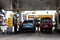 Workers at a gasoline refilling station attend to customers having their vehicles refueled