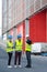 Workers in high-visibility vests by loading bays