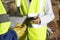 Workers Holding Clipboards In Industry