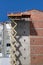 Workers on the industrial elevator repair the facade of a residential building