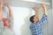 Workers installing ceiling boards building in house construction