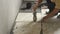 workers installs ceramic tile in floor