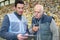 workers looking at digital tablet in recycling center