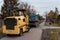 Workers with machinery preparing the road for new asphalt