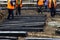 Workers make the installation of wooden sleepers for tram rails during the repair of city roads