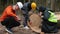 Workers measure the cut down tree. The manager processes the data in tablet.