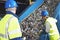 Workers Monitoring Conveyor Belt Of Recycled Cans