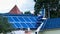 Workers mounting solar panels on residentual house.