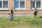 Workers mows weeds and ragweed sprouts with a gasoline scythe. Gardening care tools and equipment. Male gardeners mowing weeds