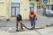 Workers in overalls install a hydrant and attach a hose