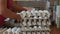 Workers pack fresh hen eggs in the sorting chicken factory