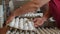 Workers pack raw hen eggs in the sorting chicken factory