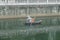 Workers paddle boats to clean up the river garbage