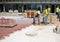 Workers in paving the sidewalk with concrete pavers