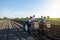 Workers are planting potatoes on the field. Automation of the process of planting potato seeds. Agricultural technologies.