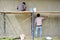 Workers plastering the brickwork wall by the cement texture for the smoothness.