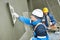 Workers at plastering facade work