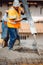 Workers pouring cement with manual pump tube