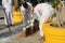 Workers are pouring gold into the mold to create a Buddha statue.