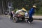 Workers pull wooden handcart