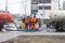 Workers pumped out the sewer near the road through the hatch with the help of two specialized cars